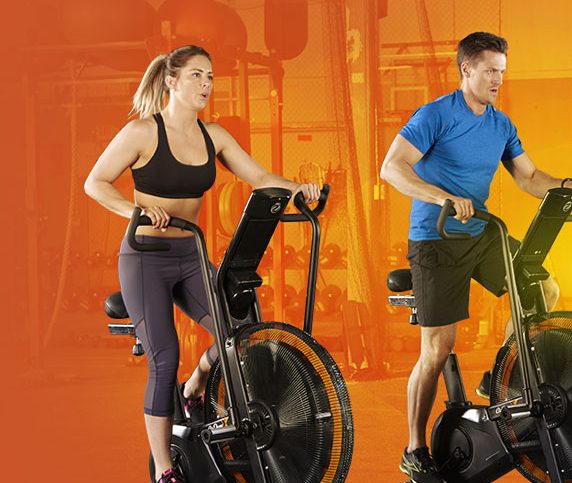 man and woman exercise using elliptical machine