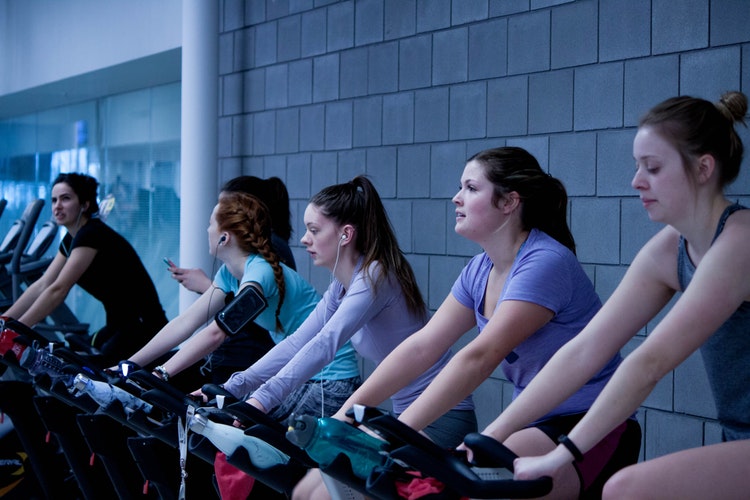 group of women doing exercise in a Stationary Bike